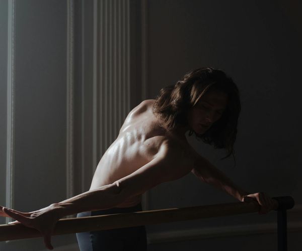 Person practicing slow strength movements focused on balance and posture.